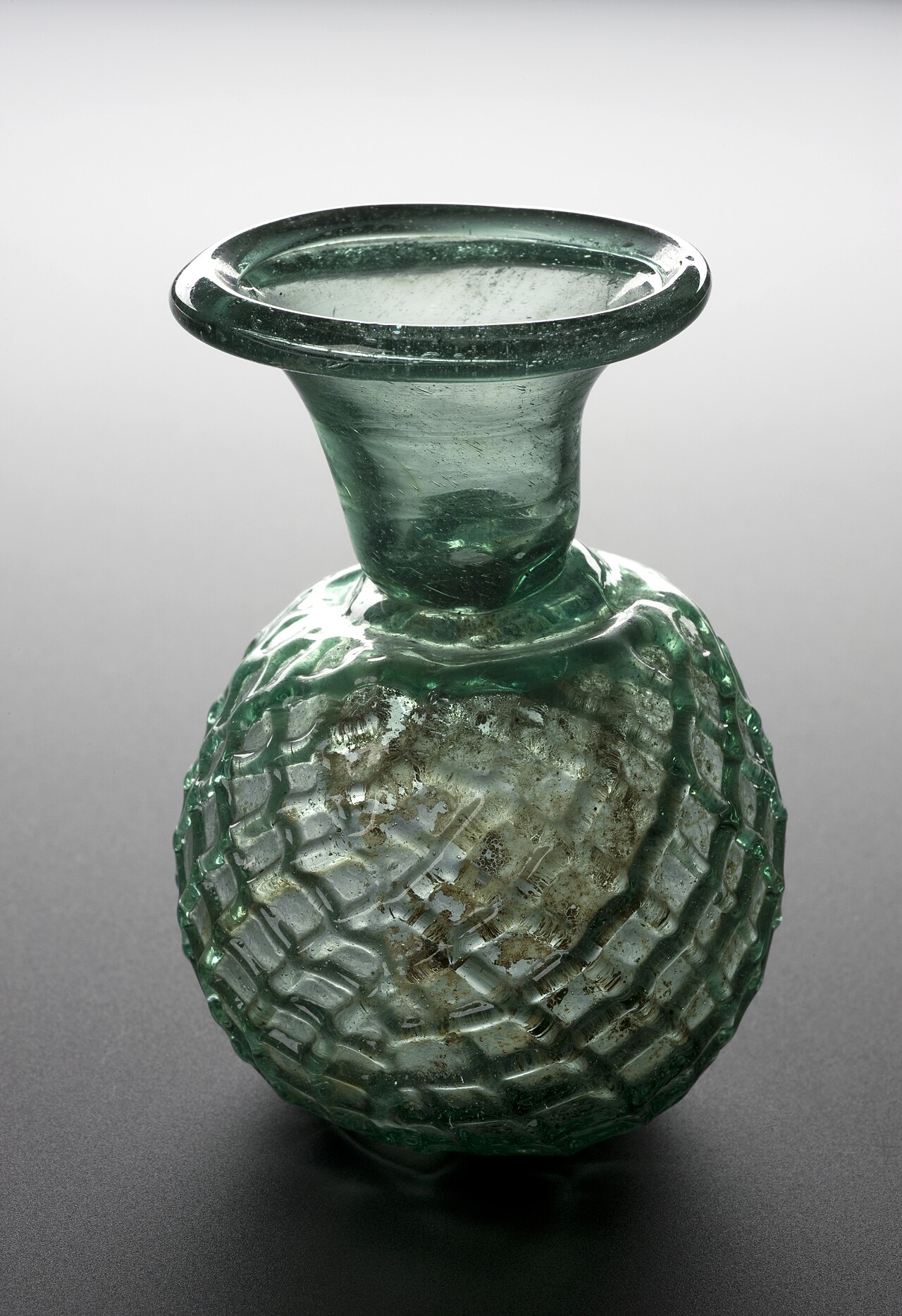 Green glass dropper bottle, Roman, 100-500 CE