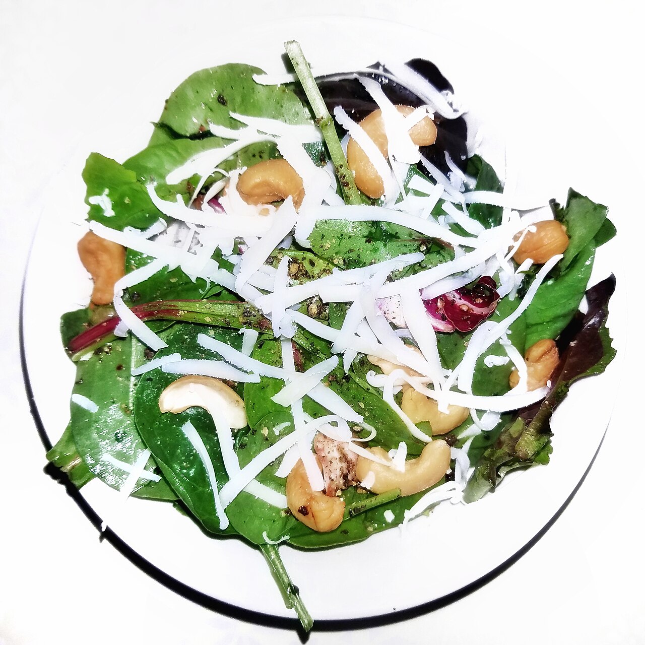 Salad of mixed greens, cashews, and cheddar cheese, with olive oil, vinegar, and black pepper - Massachusetts
