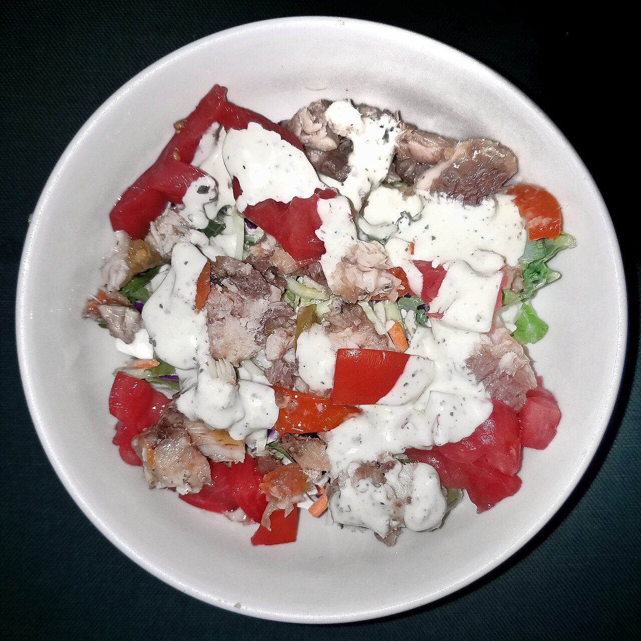 Salad of mixed greens, sardines, tomato, carrots, chili peppers, with olive oil and avocado dressing - Massachusetts