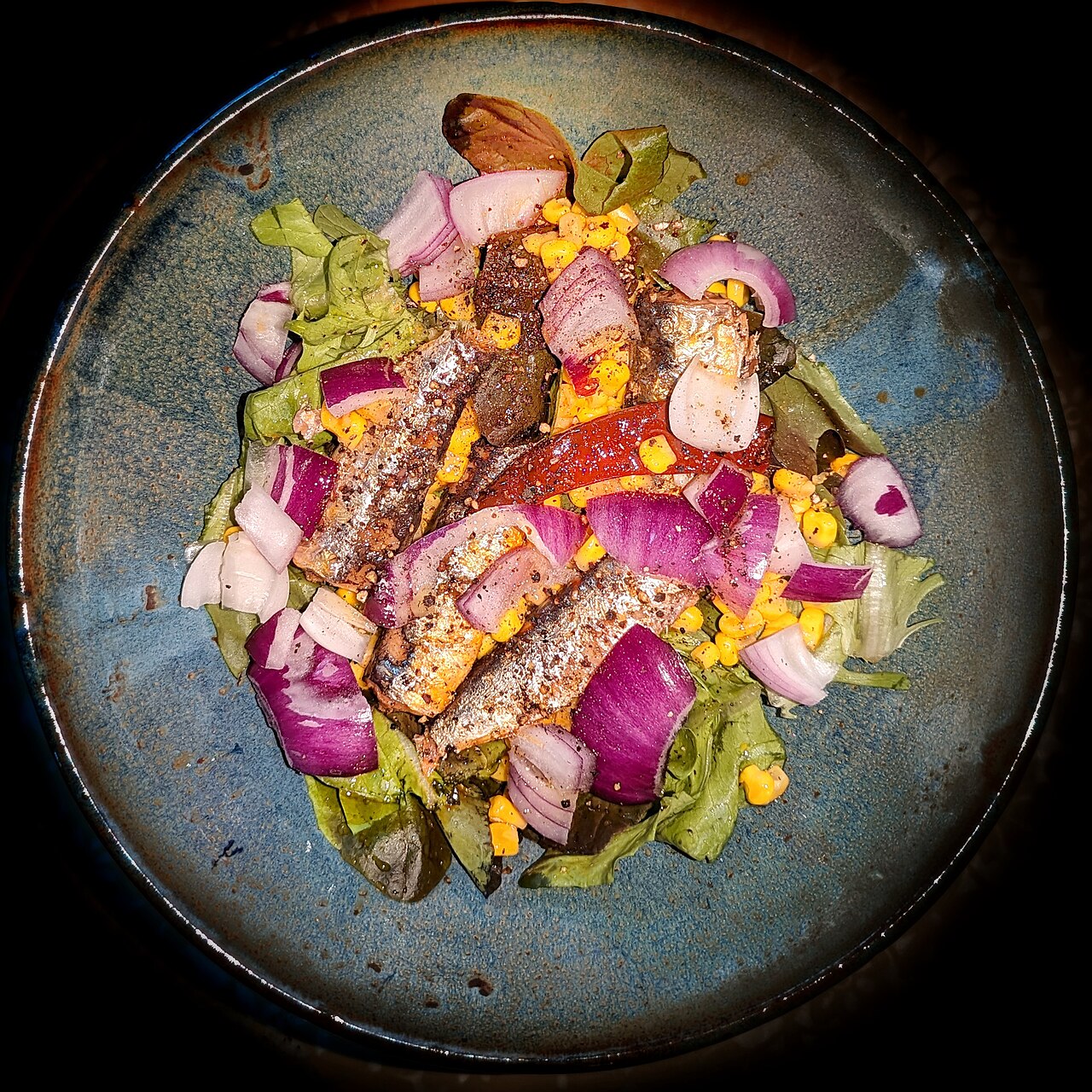 Salad of warmed sardines and corn on lettuce, with chili pepper, onion, garlic olive oil, and black pepper - Massachusetts
