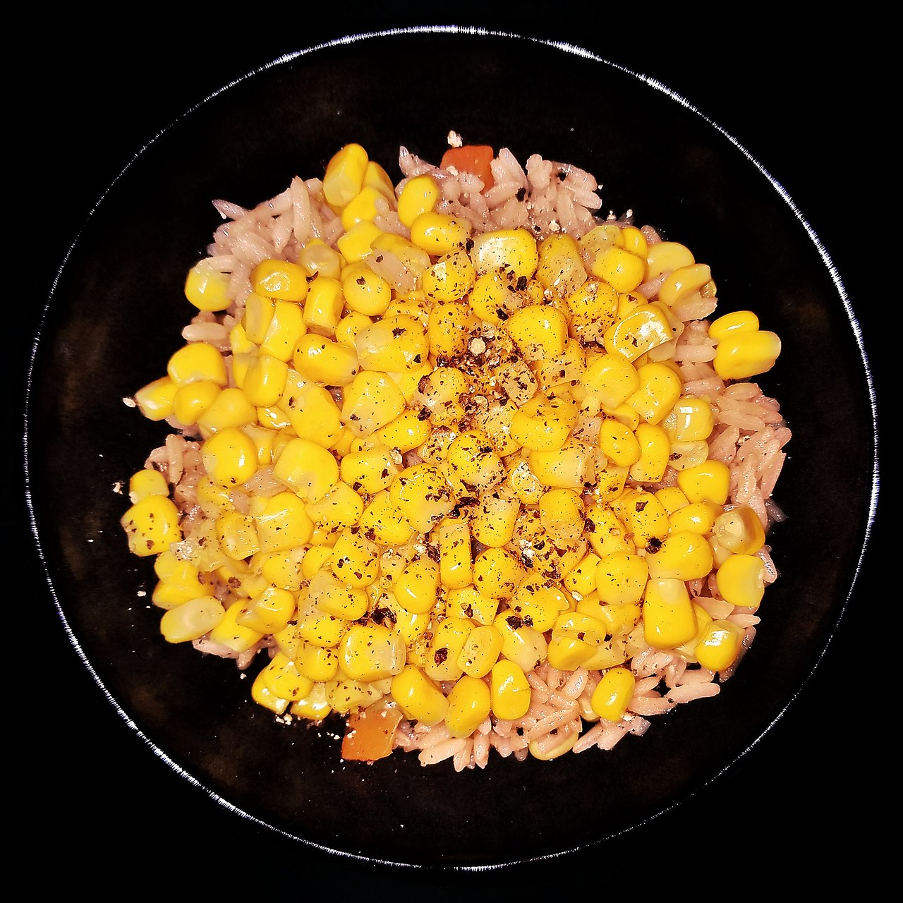 Corn, black pepper, olive oil, and garlic, atop fried rice with carrots and peas - Massachusetts